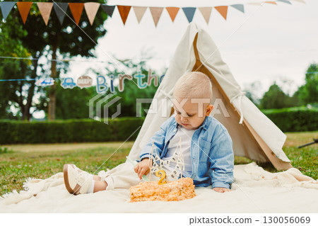 A Delightful and Sweet Birthday Celebration A Joyful Toddler Cheerfully Enjoying a Delicious Cake in a Cozy Outdoor Setting Adorned with Colorful and Festive Decorations for the Special Day A Delightful and Sweet Birthday Celebration A Joyful Toddler Cheerfully Enjoying a Delicious Cake in a Cozy Outdoor Setting Adorned with Colorful and Festive Decorations for the Special Day 130056069