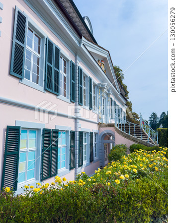 This charming and beautifully designed historic villa is nestled and surrounded by a lush, green garden filled with vibrant, colorful flowers that create a picturesque and serene environment 130056279