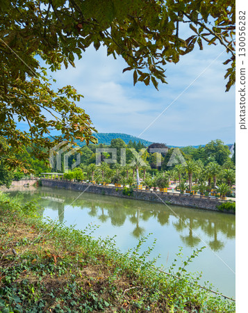 This is a beautifully tranquil riverside scene featuring lush greenery and calm waters that create a perfect atmosphere for relaxation and peace. The environment inspires a sense of harmony This is a beautifully tranquil riverside scene featuring lush greenery and calm waters that create a perfect atmosphere for relaxation and peace. The environment inspires a sense of harmony 130056282