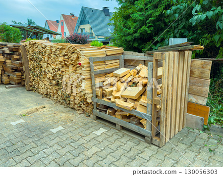 This beautiful wood storage area, with neatly stacked logs, enhances the rustic charm of outdoor spaces like backyards or gardens, making them more inviting and connected to nature This beautiful wood storage area, with neatly stacked logs, enhances the rustic charm of outdoor spaces like backyards or gardens, making them more inviting and connected to nature 130056303