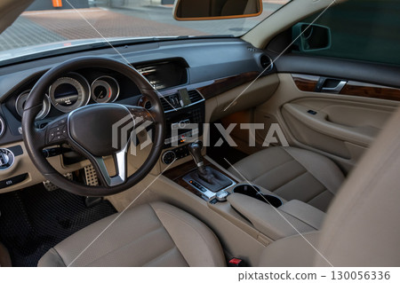 Luxurious Car Interior with Leather Seats and Modern Dashboard Technology Luxurious Car Interior with Leather Seats and Modern Dashboard Technology 130056336