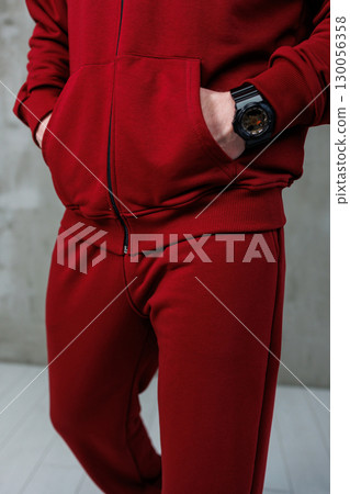 A fashionable and stylish red tracksuit paired with a modern watch serves as an excellent inspiration for urban athletic fashion enthusiasts looking to elevate their activewear wardrobe 130056358