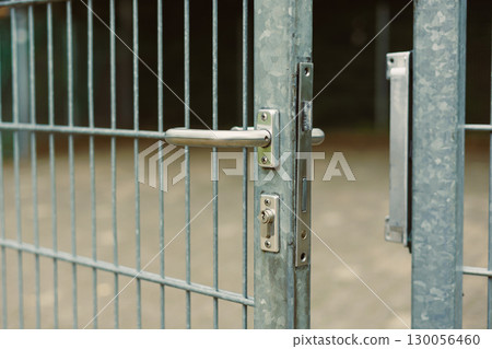 Detailed CloseUp Photography of a Metal Gate Featuring a Sturdy Locking Mechanism, Showcasing Essential Industrial Design and Key Security Features for Effective Barrier and Boundary Protection Detailed CloseUp Photography of a Metal Gate Featuring a Sturdy Locking Mechanism, Showcasing Essential Industrial Design and Key Security Features for Effective Barrier and Boundary Protection 130056460
