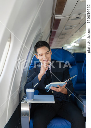 Airplane, travel and portrait of businessman working on laptop computer and smartphone while sitting in airplane. Airplane, travel and portrait of businessman working on laptop computer and smartphone while sitting in airplane. 130056662