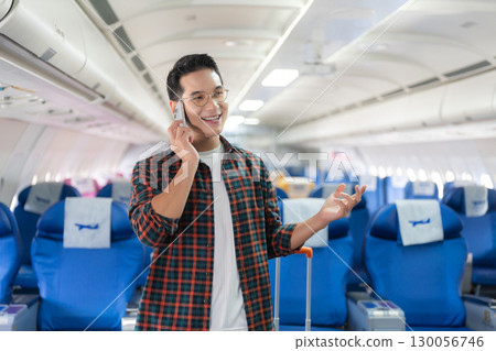man, airplane, travel, enjoying comfortable flight while sitting in the airplane cabin. 130056746