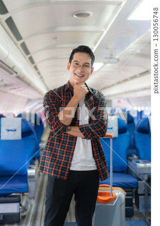 man, airplane, travel, enjoying comfortable flight while sitting in the airplane cabin. 130056748