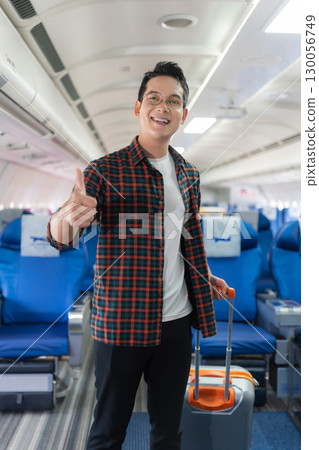 man, airplane, travel, enjoying comfortable flight while sitting in the airplane cabin. 130056749
