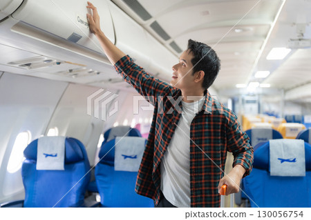 man, airplane, travel, enjoying comfortable flight while sitting in the airplane cabin. man, airplane, travel, enjoying comfortable flight while sitting in the airplane cabin. 130056754