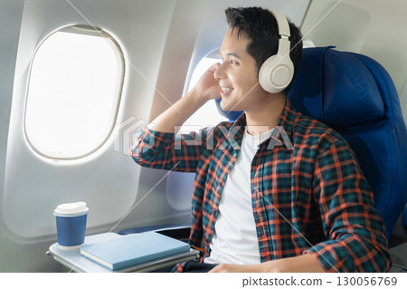 man, airplane, travel, enjoying comfortable flight while sitting in the airplane cabin. 130056769