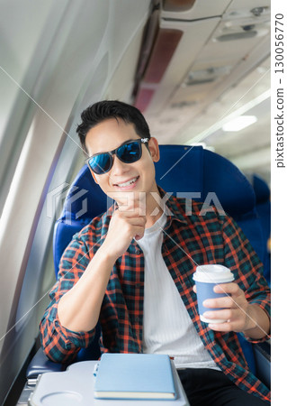 man, airplane, travel, enjoying comfortable flight while sitting in the airplane cabin. 130056770
