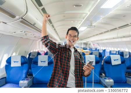 man, airplane, travel, enjoying comfortable flight while sitting in the airplane cabin. man, airplane, travel, enjoying comfortable flight while sitting in the airplane cabin. 130056772