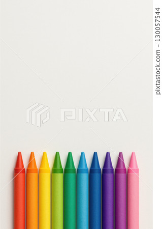 Crayon color set arranged in rainbow order on white background with wide empty space for text or design, bright and cheerful art supplies 130057544