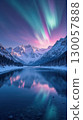 Colorful Northern Lights with pink and green hues over a winter mountain landscape 130057888