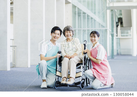 Senior woman in wheelchair and caregiver 130058044