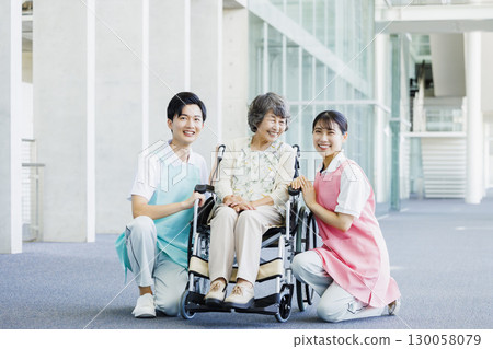 Senior woman in wheelchair and caregiver 130058079