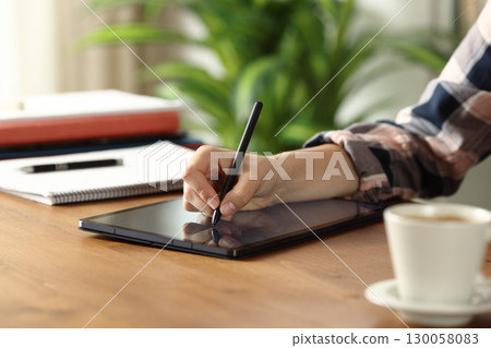Student hand handwriting notes on tablet 130058083
