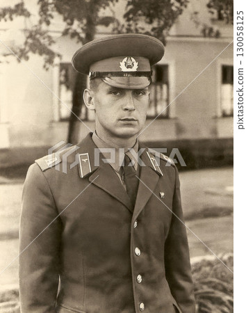 A portrait of a soldier of the Soviet red army. Vintage black and white paper photo 130058125