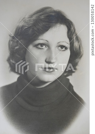 Portrait of a 20 year old Soviet brunette girl with a bob haircut taken in a studio in 1979 in the USSR. Vintage black and white photograph. Portrait of a 20 year old Soviet brunette girl with a bob haircut taken in a studio in 1979 in the USSR. Vintage black and white photograph. 130058142
