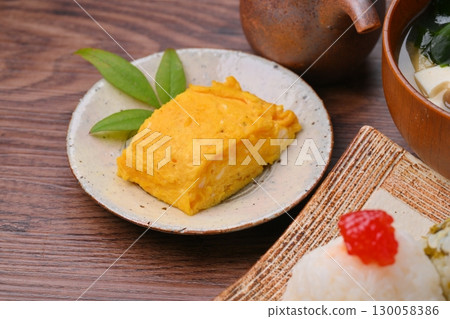 Rice ball (red roe and takana) set meal, miso soup and rolled egg. 130058386