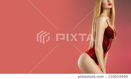 Beautiful sexy woman in red lingerie corset on red background. Valentines day erotic style. 130058400