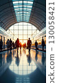 Silhouettes of commuters walking on a train station platform at sunrise 130058421