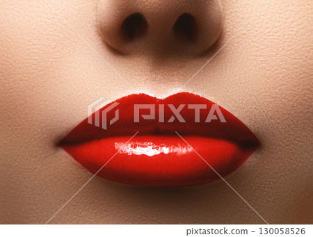 Closeup shot of beautiful full lips with red glossy make-up. Perfect bright lipstick. Plastic surgery or makeup concept Closeup shot of beautiful full lips with red glossy make-up. Perfect bright lipstick. Plastic surgery or makeup concept 130058526