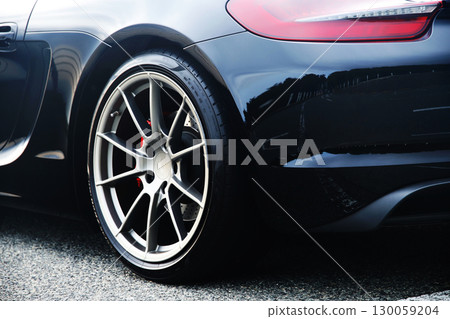 Rear tire of a black sports car 130059204