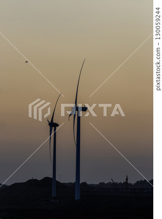 Wind Turbines Standing Tall Against a Vibrant Sunrise Backdrop in Denmark Wind Turbines Standing Tall Against a Vibrant Sunrise Backdrop in Denmark 130059244