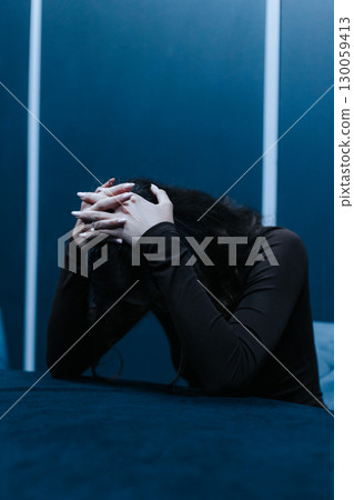 Desperate young woman on a psychotherapy reception holding head on hand, she is depressed and suffering from troubles Desperate young woman on a psychotherapy reception holding head on hand, she is depressed and suffering from troubles 130059413