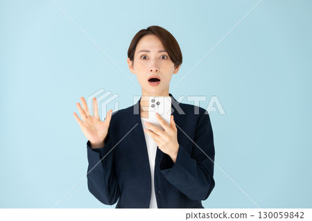 Woman business portrait smartphone surprised 130059842