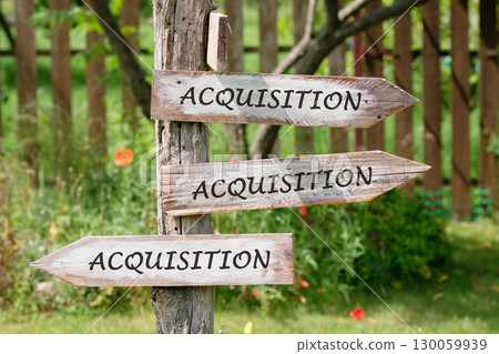 Copy space. Attraction of investments concept. ACQUISITION word written on Wooden signs indicating the directions of movement Copy space. Attraction of investments concept. ACQUISITION word written on Wooden signs indicating the directions of movement 130059939