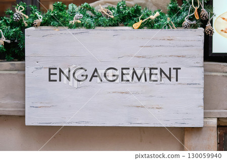 Engagement word for marketing concept. Copy space. ENGAGEMENT word written on A blank wooden sign Engagement word for marketing concept. Copy space. ENGAGEMENT word written on A blank wooden sign 130059940