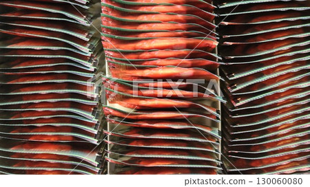 abstract textured background of square identical packages of red-green color with metallic glare, seen from above in dense rows, graphic full frame color abstraction abstract textured background of square identical packages of red-green color with metallic glare, seen from above in dense rows, graphic full frame color abstraction 130060080