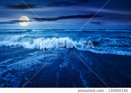 sea tide before storm at night. wave splash with foam on wet sandy beach in full moon light. windy weather on velvet season. dramatic seascape background sea tide before storm at night. wave splash with foam on wet sandy beach in full moon light. windy weather on velvet season. dramatic seascape background 130060180