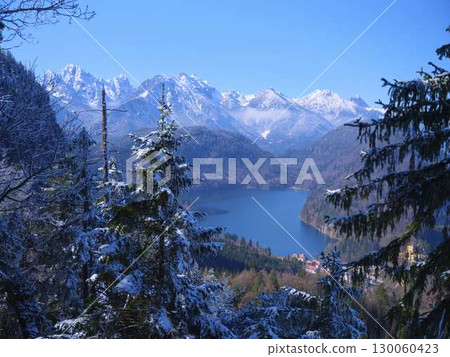 Stunning winter landscape with snow-covered mountains and a serene lake in southern Germany 130060423
