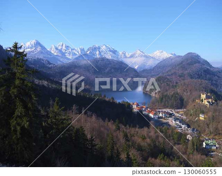 Stunning mountain landscape with lake, castle, and forests in Bavaria during clear day 130060555