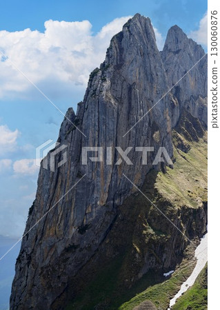 Spectacular mountain peaks rise against a clear blue sky in a breathtaking landscape view 130060876