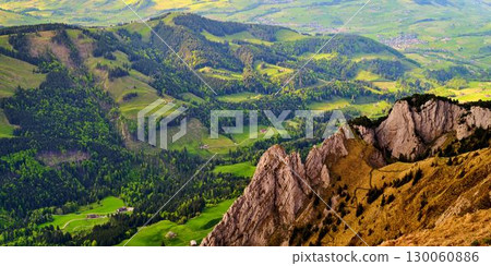 Scenic mountain view showcasing lush valleys and rocky outcrops during daytime in a rural landscape 130060886