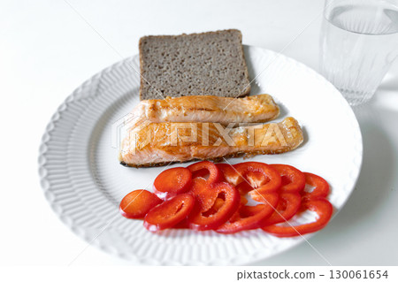 Plate of fried fish, bread, red pepper 130061654