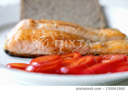 Plate of fried fish, bread, red pepper 130061660