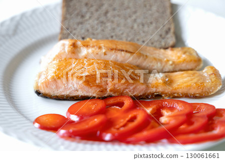 Fried fish served with bread and pepper 130061661