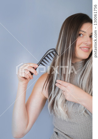 Beautiful hair extensions wide tooth comb providing gentle care and preventing damage in professional salon 130061756