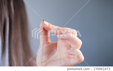 Fashion look of young woman with natural brown and white hair extensions stylish hairstyle in modern beauty salon 130061873