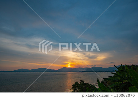 Scene of Colorful romantic sky sunset with orange color of the sky background. 130062070