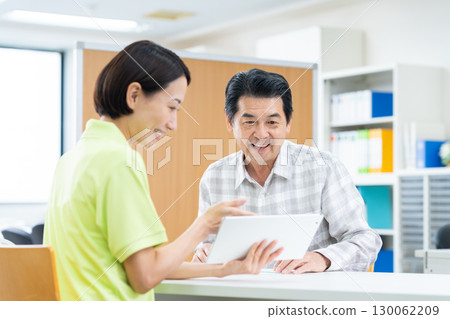 Senior man consulting with care manager 130062209