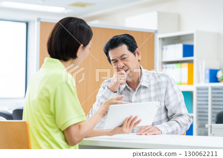Senior man consulting with care manager Senior man consulting with care manager 130062211