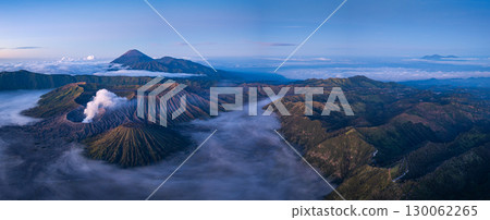 Aerial View of Dramatic landscapes and mist surround Mount Bromo. 130062265