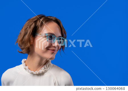 Smiling Woman In Transparent Blue Glasses. Positive Stylish Lady, copy space Smiling Woman In Transparent Blue Glasses. Positive Stylish Lady, copy space 130064068
