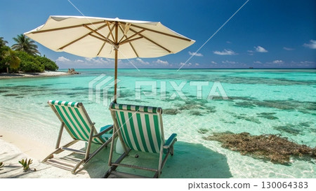 Scenic tropical beach with two colorful striped deck chairs under a large parasol Scenic tropical beach with two colorful striped deck chairs under a large parasol 130064383