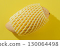 Mango Wrapped in Foam Net on a Yellow Background 130064498